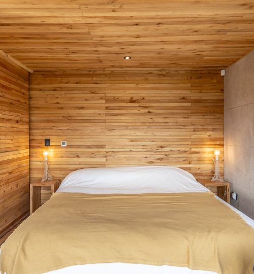 Interior diurno del dormitorio de una Cabaña de 'La Calma Ecolodge' en Potrerillos, Mendoza, Argentina.